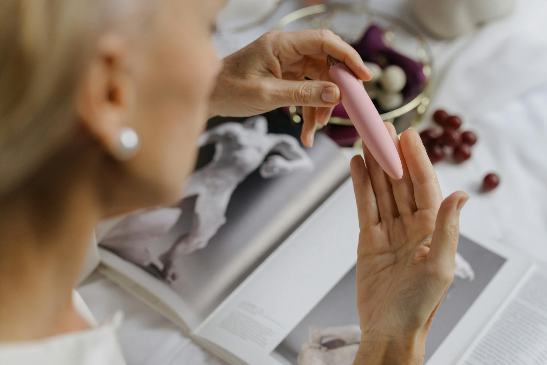 A woman confidently holding vibrators, representing self-advocacy and pleasure ownership in relationships.